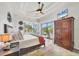 Inviting main bedroom with a ceiling fan, a view of the screened-in pool, and wooden flooring at 14398 Fort Worth Cir, Port Charlotte, FL 33981