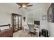 Home office with a large window, a built-in desk, and a glass-front display cabinet at 14398 Fort Worth Cir, Port Charlotte, FL 33981