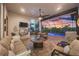 Screened patio with comfortable seating, a fire pit coffee table, and views of the pool and sunset at 14398 Fort Worth Cir, Port Charlotte, FL 33981