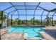 Sparkling pool is enclosed within a screened lanai, and it overlooks a picturesque canal at 14398 Fort Worth Cir, Port Charlotte, FL 33981