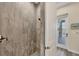 Modern tiled shower with stylish fixtures and direct access to the outdoor lanai and pool area at 14398 Fort Worth Cir, Port Charlotte, FL 33981