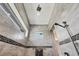 Walk-in shower featuring stylish tile walls, a rain shower head, and natural light from a window for a luxurious feel at 14398 Fort Worth Cir, Port Charlotte, FL 33981