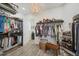 Luxurious walk-in closet with custom shelving, wood floors, and a stylish chandelier with easy access to laundry at 14398 Fort Worth Cir, Port Charlotte, FL 33981
