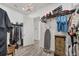 Spacious walk-in closet with custom shelving, elegant chandelier, and ample storage for clothes and accessories at 14398 Fort Worth Cir, Port Charlotte, FL 33981