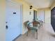 Balcony with unit 202's door, tile flooring, and cozy outdoor seating at 1531 Placida Rd # 202 Building 9, Englewood, FL 34223