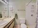 Bright bathroom featuring a shower with white tiles, a vanity sink, and decorative wall art at 1531 Placida Rd # 202 Building 9, Englewood, FL 34223