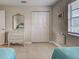 Bedroom with tiled floor, decorated dresser, closet with louvered doors, and a window with blinds at 1531 Placida Rd # 202 Building 9, Englewood, FL 34223