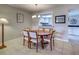 Dining area with a wooden table, six chairs, and a view into the bright kitchen through a pass-through at 1531 Placida Rd # 202 Building 9, Englewood, FL 34223