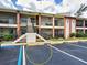 Close-up of the condo building highlighting the private balcony and stair access at 1531 Placida Rd # 202 Building 9, Englewood, FL 34223