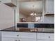 Bright kitchen pass-through with granite countertops and white cabinets offers a view to the open-plan living area at 1531 Placida Rd # 202 Building 9, Englewood, FL 34223