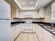 Modern kitchen with white appliances, white cabinets, granite countertops, and a tiled floor at 1531 Placida Rd # 202 Building 9, Englewood, FL 34223