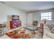 Well-lit living room with a patterned rug, a decorative cabinet, and comfortable seating area near the entrance at 1531 Placida Rd # 202 Building 9, Englewood, FL 34223