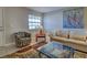 Living room featuring a stylish rug, cozy seating, and a glass coffee table at 1531 Placida Rd # 202 Building 9, Englewood, FL 34223
