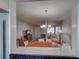 Bright open-plan living area with light walls and a pendant light fixture, as seen from the kitchen pass-through at 1531 Placida Rd # 202 Building 9, Englewood, FL 34223