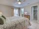 Large main bedroom featuring a tiled floor, a ceiling fan, and a private balcony overlooking neighborhood at 1531 Placida Rd # 202 Building 9, Englewood, FL 34223