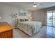 Comfortable bedroom featuring a tiled floor, a large window, soft lighting, and a relaxing neutral color scheme at 1531 Placida Rd # 202 Building 9, Englewood, FL 34223