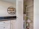 Pantry with white cabinets, shelving, and a water heater at 1531 Placida Rd # 202 Building 9, Englewood, FL 34223