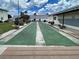 Enjoy a game of shuffleboard on this well-maintained court, a fun amenity for residents in a beautiful community setting at 1531 Placida Rd # 202 Building 9, Englewood, FL 34223
