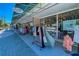 Sidewalk view of Green Artist store with clothing racks and window displays at 1531 Placida Rd # 202 Building 9, Englewood, FL 34223