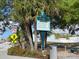 Dearborn Street sign amidst palm trees, traffic signs, and directions to local attractions at 1531 Placida Rd # 202 Building 9, Englewood, FL 34223