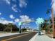 View of Dearborn Street entrance with palm tree decorations and a clear blue, partly cloudy sky at 1531 Placida Rd # 202 Building 9, Englewood, FL 34223