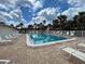 Refreshing swimming pool with lounge chairs and lush palm trees at 1531 Placida Rd # 202 Building 9, Englewood, FL 34223