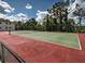 Well-maintained tennis court surrounded by lush greenery, perfect for recreational play at 1531 Placida Rd # 202 Building 9, Englewood, FL 34223