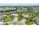 Stunning aerial view of waterfront homes with lush landscaping and private docks on a sunny day at 15336 Spanish Point Dr, Port Charlotte, FL 33981