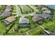 Scenic aerial view of a home with a screened pool, lush backyard, and canal access with a private dock at 15336 Spanish Point Dr, Port Charlotte, FL 33981