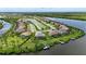 Panoramic aerial showcasing waterfront homes with docks and beautiful landscaping, offering serene water access at 15336 Spanish Point Dr, Port Charlotte, FL 33981