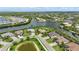 Capture stunning aerial views of a luxurious community featuring beautiful waterfront properties and a tranquil pond at 15336 Spanish Point Dr, Port Charlotte, FL 33981
