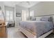 Bedroom with a grey comforter and a bench under the window at 15336 Spanish Point Dr, Port Charlotte, FL 33981