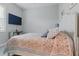 Cozy bedroom with a patterned bedspread and mounted TV at 15336 Spanish Point Dr, Port Charlotte, FL 33981