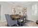 Elegant dining room featuring a contemporary chandelier, stylish decor, and ample natural light at 15336 Spanish Point Dr, Port Charlotte, FL 33981