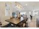 Open dining area with a modern chandelier, wooden table, and view to the living area at 15336 Spanish Point Dr, Port Charlotte, FL 33981