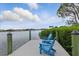 A pair of chairs sit on a private dock overlooking the lake at 15336 Spanish Point Dr, Port Charlotte, FL 33981