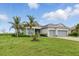 Charming single-story home with a three-car garage, beautiful landscaping, and a paver driveway at 15336 Spanish Point Dr, Port Charlotte, FL 33981
