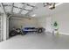A spacious two car garage containing a variety of storage and transportation items at 15336 Spanish Point Dr, Port Charlotte, FL 33981