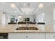 Spacious kitchen island with seating, granite countertops, and modern faucet fixture at 15336 Spanish Point Dr, Port Charlotte, FL 33981