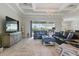 Spacious living room features tray ceilings, tile floors, and large windows overlooking the lanai at 15336 Spanish Point Dr, Port Charlotte, FL 33981