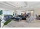 Open-concept living room with modern lighting, plush seating, and views of outdoor space at 15336 Spanish Point Dr, Port Charlotte, FL 33981