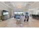 Spacious living room features tray ceilings, tile floors, and large windows overlooking the lanai at 15336 Spanish Point Dr, Port Charlotte, FL 33981