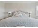 The main bedroom is shown with a large bed with grey and white linens at 15336 Spanish Point Dr, Port Charlotte, FL 33981