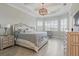 Spacious bedroom with tray ceiling, tile floors, and ample natural light from shuttered windows at 15336 Spanish Point Dr, Port Charlotte, FL 33981