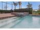 Sparkling pool with in-ground spa features tile detail and a screened lanai, perfect for outdoor entertaining at 15336 Spanish Point Dr, Port Charlotte, FL 33981