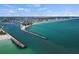 Expansive aerial view of beach, piers, and coastline with gorgeous blue water and partly cloudy skies at 1555 Tarpon Center Dr # G 235, Venice, FL 34285