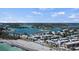 Stunning aerial view of waterfront community with lush greenery, boat docks, condos, and sandy beach at 1555 Tarpon Center Dr # G 235, Venice, FL 34285