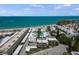 Breathtaking aerial view of beachside condos with white roofs, set against a turquoise ocean backdrop at 1555 Tarpon Center Dr # G 235, Venice, FL 34285
