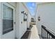Welcoming condo entryway with a security door, textured walls, and accent lighting at 1555 Tarpon Center Dr # G 235, Venice, FL 34285