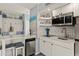 Well-lit kitchen featuring stainless appliances, subway tile backsplash, and breakfast bar at 1555 Tarpon Center Dr # G 235, Venice, FL 34285